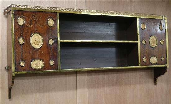A 19th century brass-bound inlaid mahogany wall-hanging bookshelf, W.114.5cm